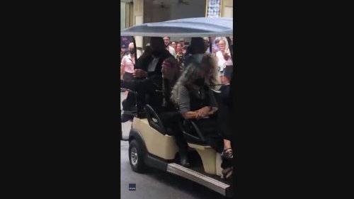 Dolly Parton and Willie Nelson Wave to Fans in Dollywood Golf Cart Drive-By