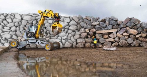 Robotic excavator builds a giant stone wall with no human assistance