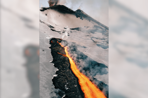 Someone should probably tell these skiiers that Mt. Etna is erupting 