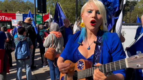 Pro-European Union protester dressed in blue entertains large crowds at London rally with a song