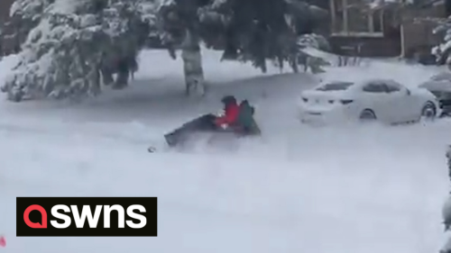 Daredevil performs a snowmobile drive-by in a residential street in Ottawa during blizzard