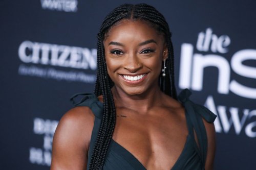 Simone Biles Strikes A Pose In Barely There Heels And Floral Thigh High Slit Skirt With Crop Top