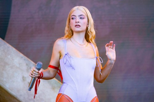 Lorde Debuts Platinum Blond Hair in Purple Swimsuit, Red Tights & Prada Loafers at Glastonbury Festival