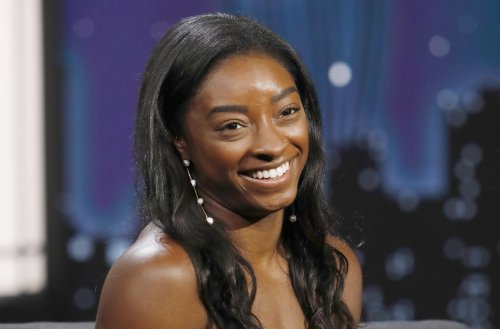 Simone Biles Chicly Catches Big Fish That Reaches Her Height in Crop Top, Cutoff Shorts & Quilted Slides
