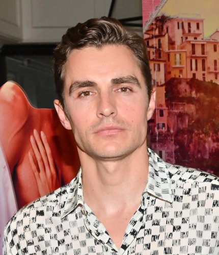 Dave Franco Masters Strategic Dressing In Geometric Top, Flattering Trousers & Shiny Loafers With Alison Brie for ‘Spin Me Round’ Premiere