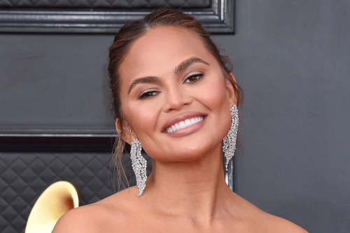 Chrissy Teigen Embraces Lingerie Inspiration in Sheer Lace Camisole, Hot Pants & 7-Inch Versace Heels