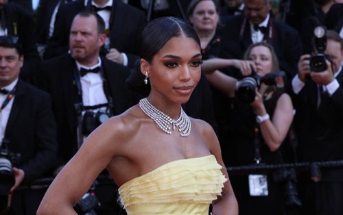 Lori Harvey Exudes Gilded Glamour In Ruffled Yellow Ballgown & Gold Heels at Cannes Film Festival 2022