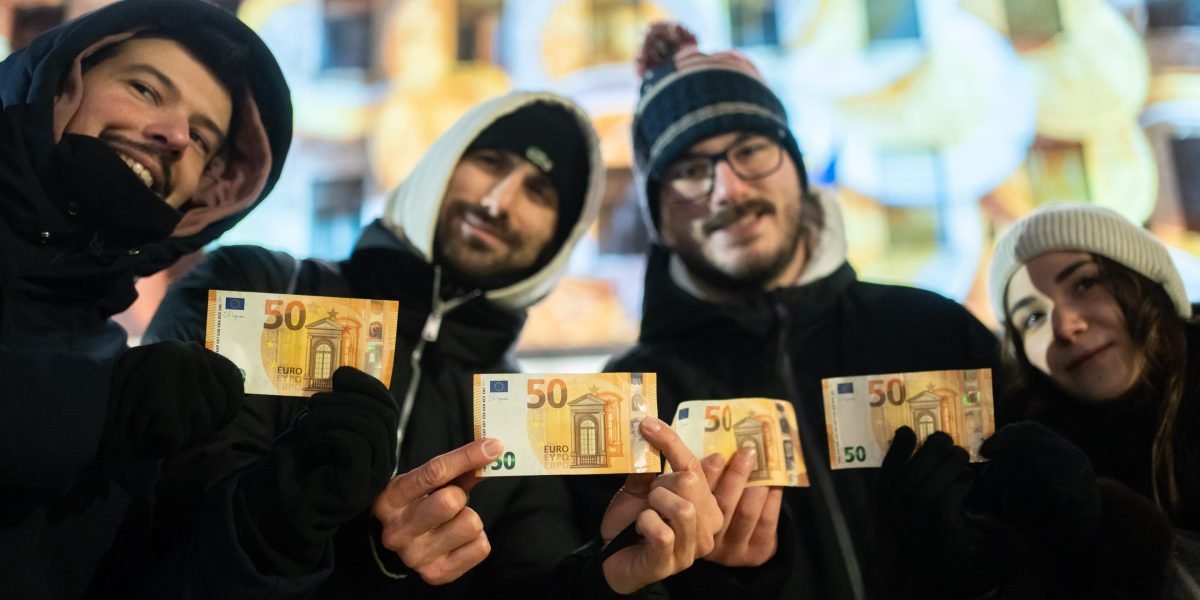 Cash machines in this former communist country issue euros for the first time after becoming the 21st member of the currency union