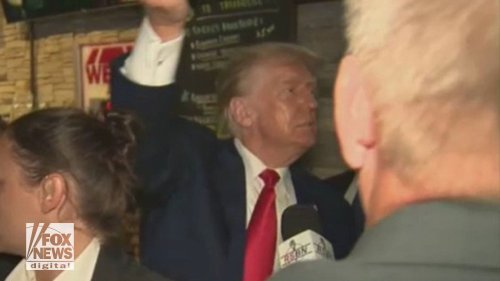 WATCH: Trump hands out pizzas to swarm of supporters at Iowa pub