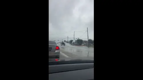 Travelers in Baytown, Texas, drive through the flood waters as the city experiences more damp weather
