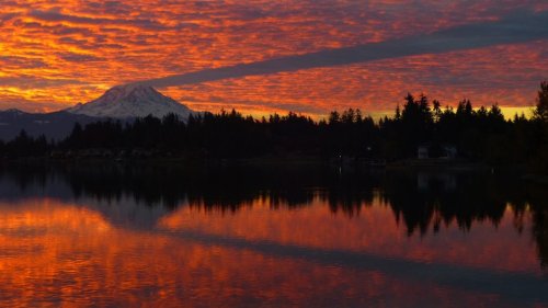 Skies erupt in color during dramatic sunrise near Washington's Mt. Rainier
