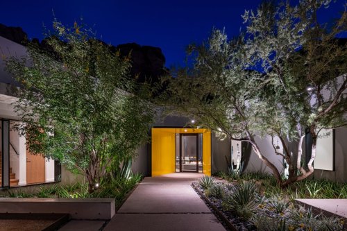 8 tricks for lighting your front door that architects use to make homes look amazing at nighttime