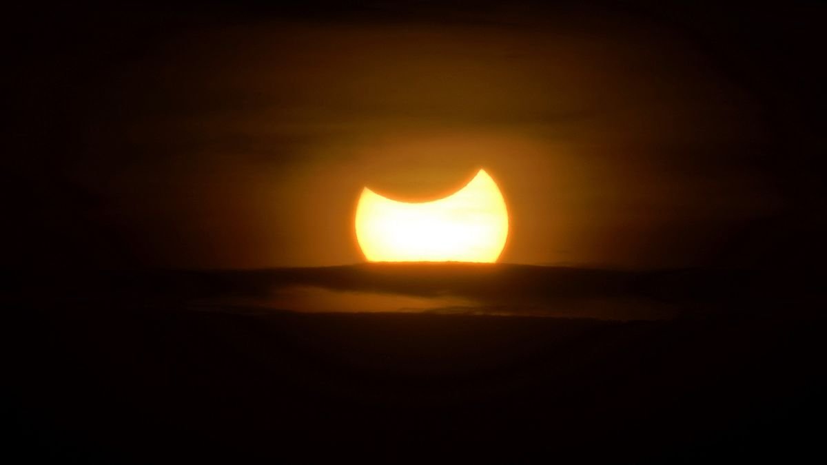 The moon blocks the sun in a rare hybrid solar eclipse today