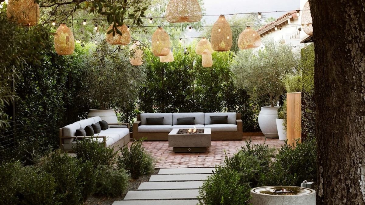 This landscape designer's idea for elevating a string light canopy has created one of the dreamiest backyards I've seen