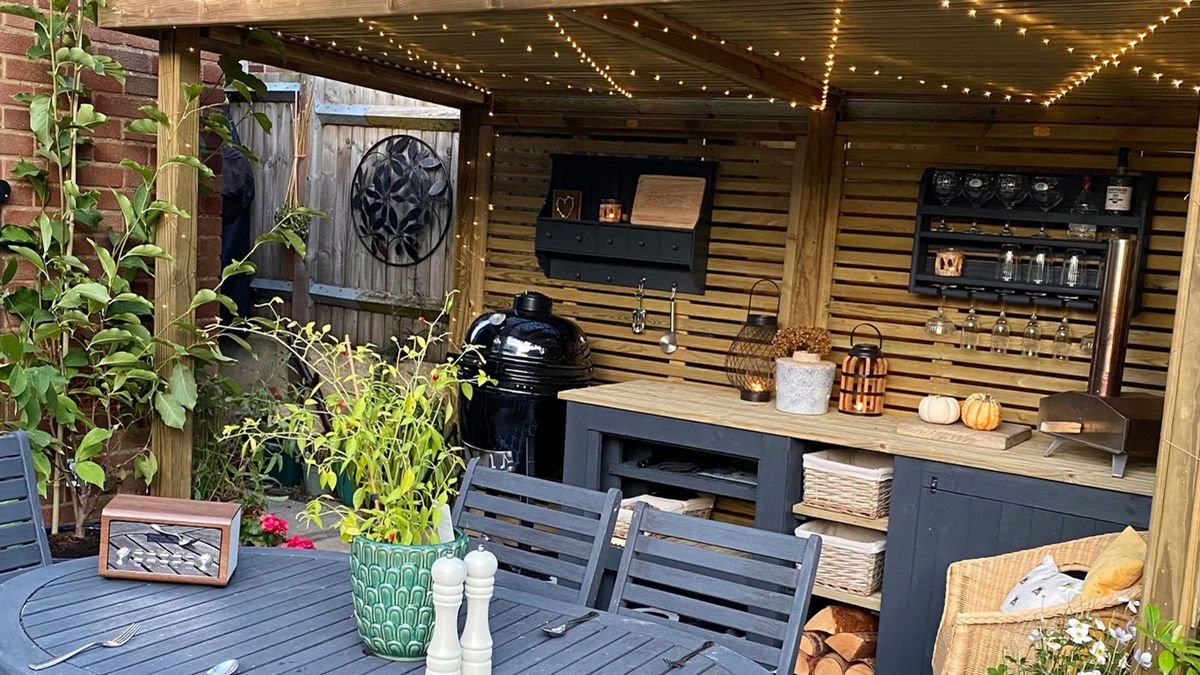 A couple has made a cozy DIY garden shelter out of fence panels