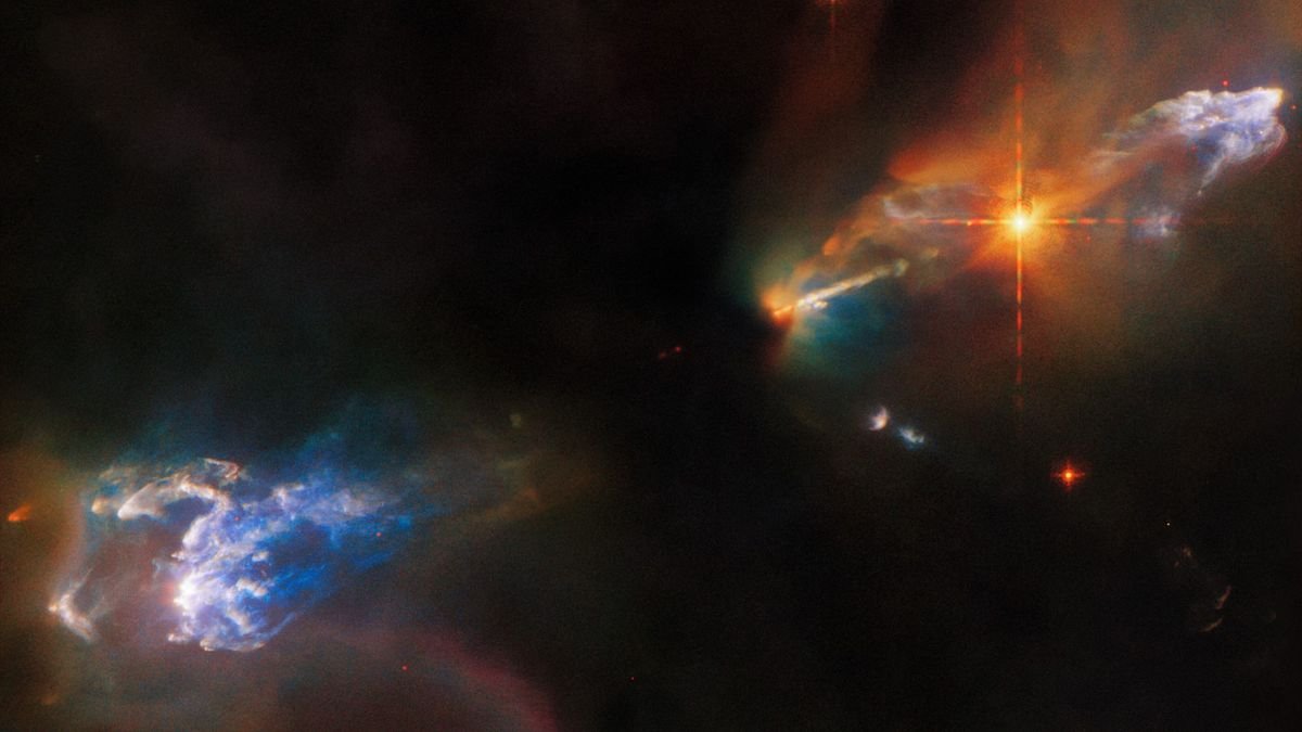 Newborn twin stars blast out jets of rainbow-colored gas in new Hubble image