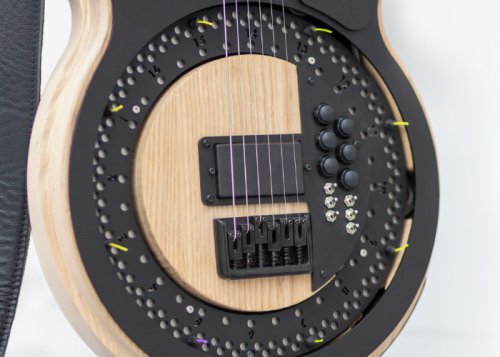 Unique Circle Guitar equipped with a spinning disc for picks
