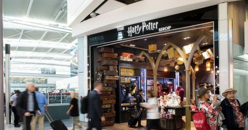 Tom Felton poses in front of Harry Potter shop at Heathrow