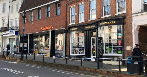 Police cordon outside Sainsbury's store in Surrey as shops shut