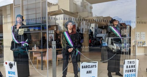 Live as Guildford Barclays XR protesters dressed as Suffragettes chain themselves together