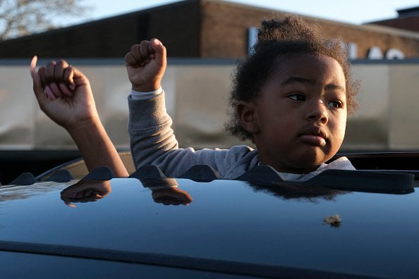 A child holds up her fist in Columbus