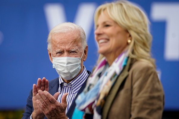 Democratic presidential nominee Joe Biden listens as his wife Dr....