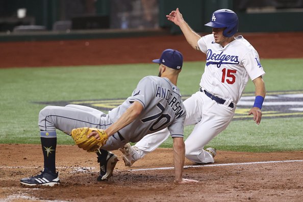 Austin Barnes of the Los Angeles Dodgers slides in safely past Nick...
