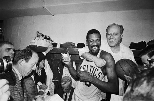 A happy twosome shown here, is Red Auerbach who coached his last...
