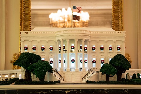 A White House gingerbread house is displayed in the State Dining Room