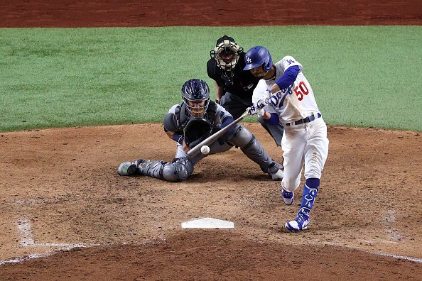 Mookie Betts of the Los Angeles Dodgers hits a solo home run against...