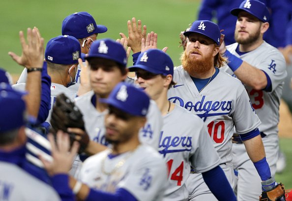 Justin Turner of the Los Angeles Dodgers celebrates with teammates...