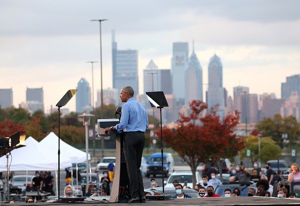 Former U.S. President Barack Obama speaks during a drive-in rally...