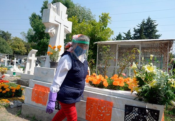 A woman visits a relative's grave prior to the Day of the Dead at the...