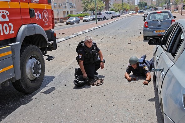 Israeli Security Forces Take Cover From Rockets