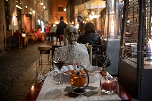 A skeleton is seen at a restaurant table to protest against the new...