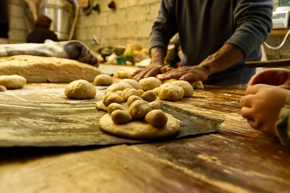 A baker during the preparation of the traditional bread of the dead ....