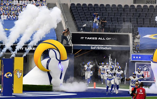 Los Angeles Rams take the field in front of an empty stadium prior to...