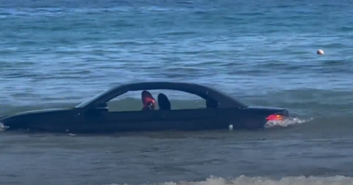 BMW convertible drifts out to sea after driver parked car on the beach ...