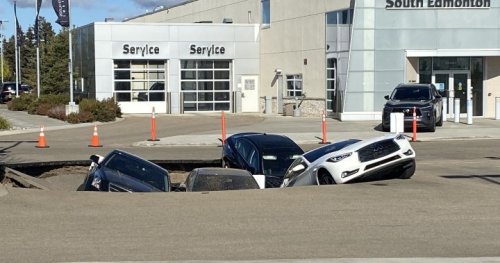 Sinkhole swallows several cars at south Edmonton dealership