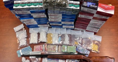 Dauphin woman in custody after Manitoba RCMP seizes drugs, rifle, illegal cigarettes, and more