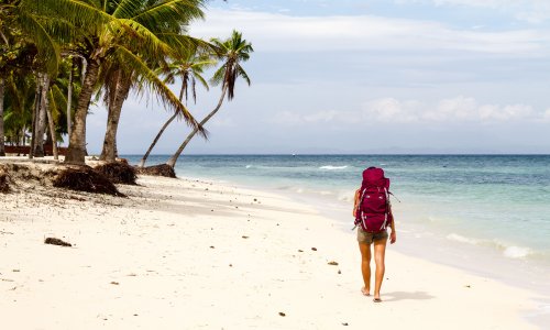 Why is travelling alone still considered a risky, frivolous pursuit for women?