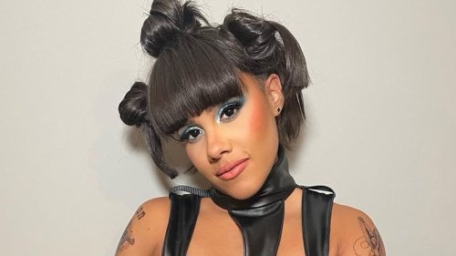 Alex Scott dances in vampy vinyl catsuit and knee-high boots