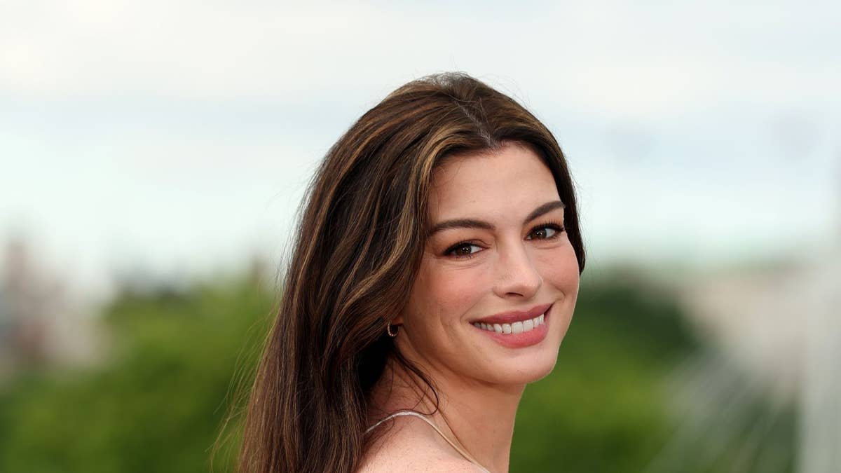 Pregnant Anne Hathaway looks incredible in flowy white dress in star studded appearance