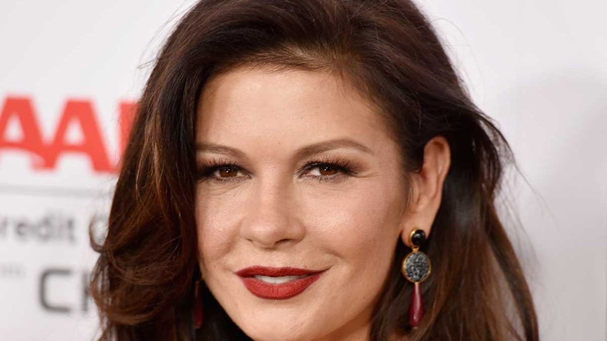 Catherine Zeta-Jones dazzles in bold gown alongside rarely-seen son