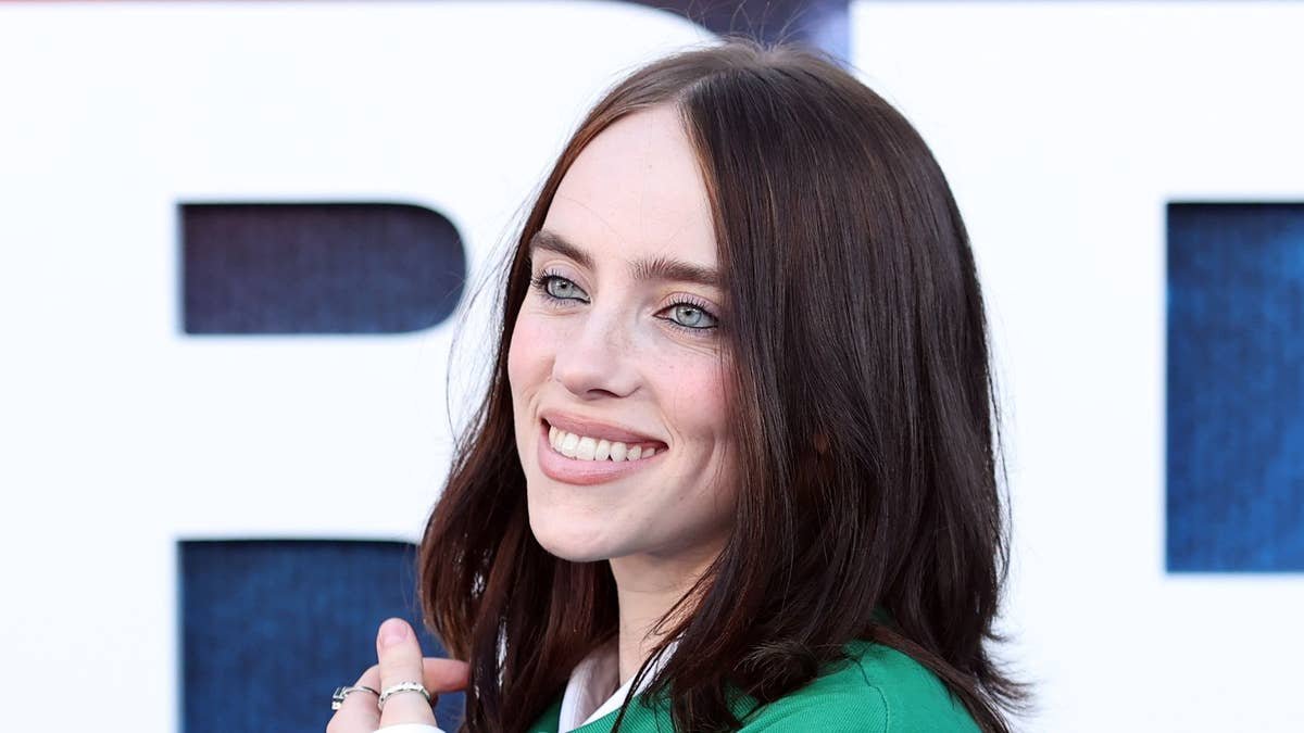 Billie Eilish changes into second satin look to perform at brother Finneas' wedding to Claudia Sulewski