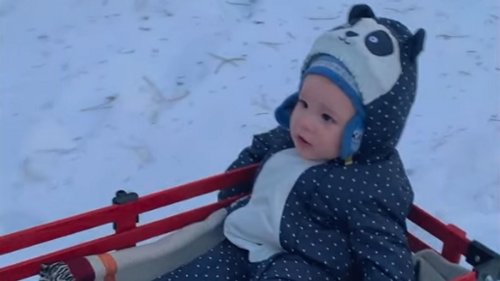 Meghan Markle cheers as she pulls son Archie on a sleigh in the snow