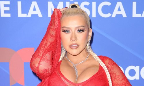 Christina Aguilera shares revealing new photos as she poses in black leather gloves