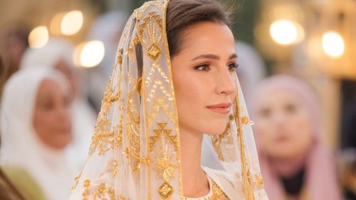 Crown Prince Hussein's resplendent bride Rajwa models fitted wedding dress with dramatic train