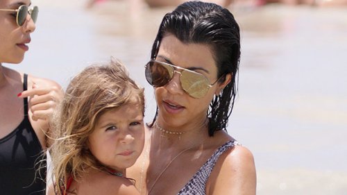 Kourtney Kardashian Wears Pink Wetsuit & Cuddles Daughter Penelope, 10, On A Boat: Photos