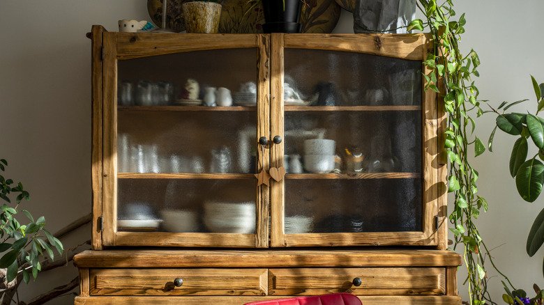 Repurpose Grandma's Curio For Extra Bathroom Storage With This Easy DIY